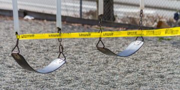 A set of swings are caution taped off during COVID-19 prevention measures.