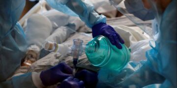 FILE PHOTO: Critical care workers insert an endotracheal tube into a coronavirus disease (COVID-19) positive patient in the intensive care unit (ICU) at Sarasota Memorial Hospital in Sarasota, Florida, February 11, 2021. REUTERS/Shannon Stapleton/File Photo