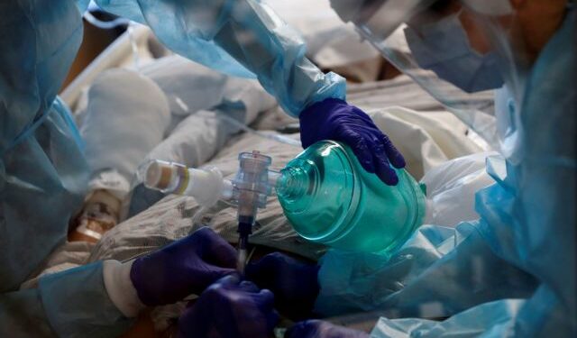 FILE PHOTO: Critical care workers insert an endotracheal tube into a coronavirus disease (COVID-19) positive patient in the intensive care unit (ICU) at Sarasota Memorial Hospital in Sarasota, Florida, February 11, 2021. REUTERS/Shannon Stapleton/File Photo