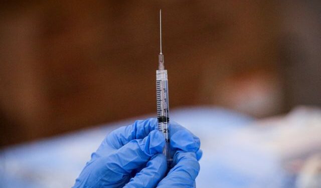 FILE PHOTO: FILE PHOTO: A syringe is filled with a dose of Pfizer's COVID-19 vaccine at a pop-up community vaccination center at the Gateway World Christian Center in Valley Stream, New York, U.S., February 23, 2021.  REUTERS/Brendan McDermid/File Photo