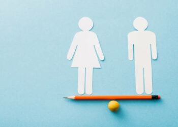 small ball and pencil with paper cut of couple isolated on blue, sexual equality concept