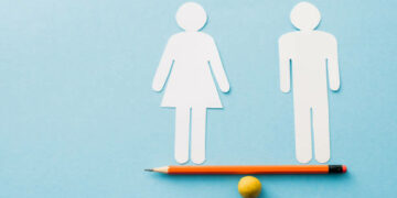 small ball and pencil with paper cut of couple isolated on blue, sexual equality concept