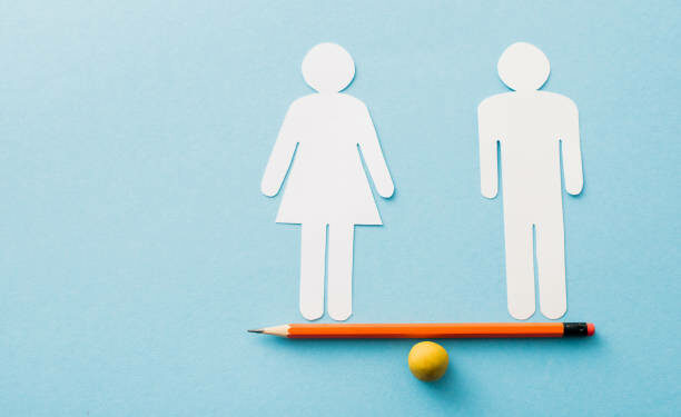 small ball and pencil with paper cut of couple isolated on blue, sexual equality concept