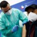 A person receives a dose of the Moderna vaccine against the coronavirus disease (COVID-19), on the day the government is expected to approve new rules for schools and COVID-19 vaccination for workers, at the Music Auditorium in Rome, Italy, January 5, 2022. REUTERS/Guglielmo Mangiapane