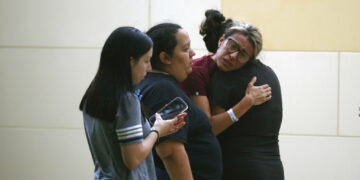 People react outside the Civic Center following a deadly school shooting at Robb Elementary School in Uvalde, Texas Tuesday, May 24, 2022. (AP Photo/Dario Lopez-Mills)