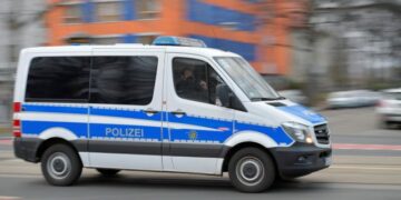 A police vehicle drives during a demonstration against government measures to curb the spread of the coronavirus disease (COVID-19) in Dresden, Germany, January 22, 2022. REUTERS/Matthias Rietschel