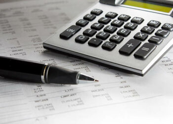 "Photo of a calculator, with a pen, above a paper with numbers.Business.Please, see more pictures on my lightbox"