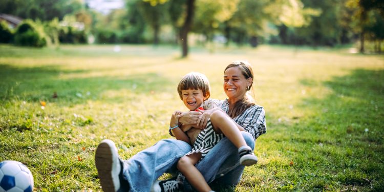 Mother and son play together in the park