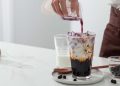 A man is making brown sugar vanilla pearl milk tea